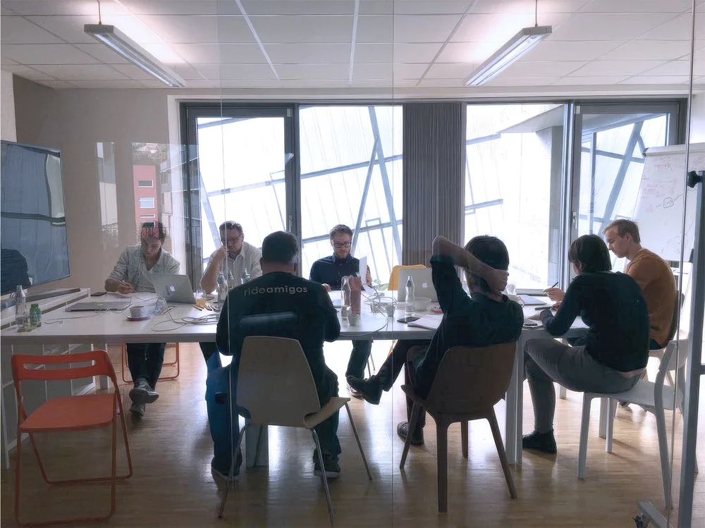 Team members in a meeting room discussing findings